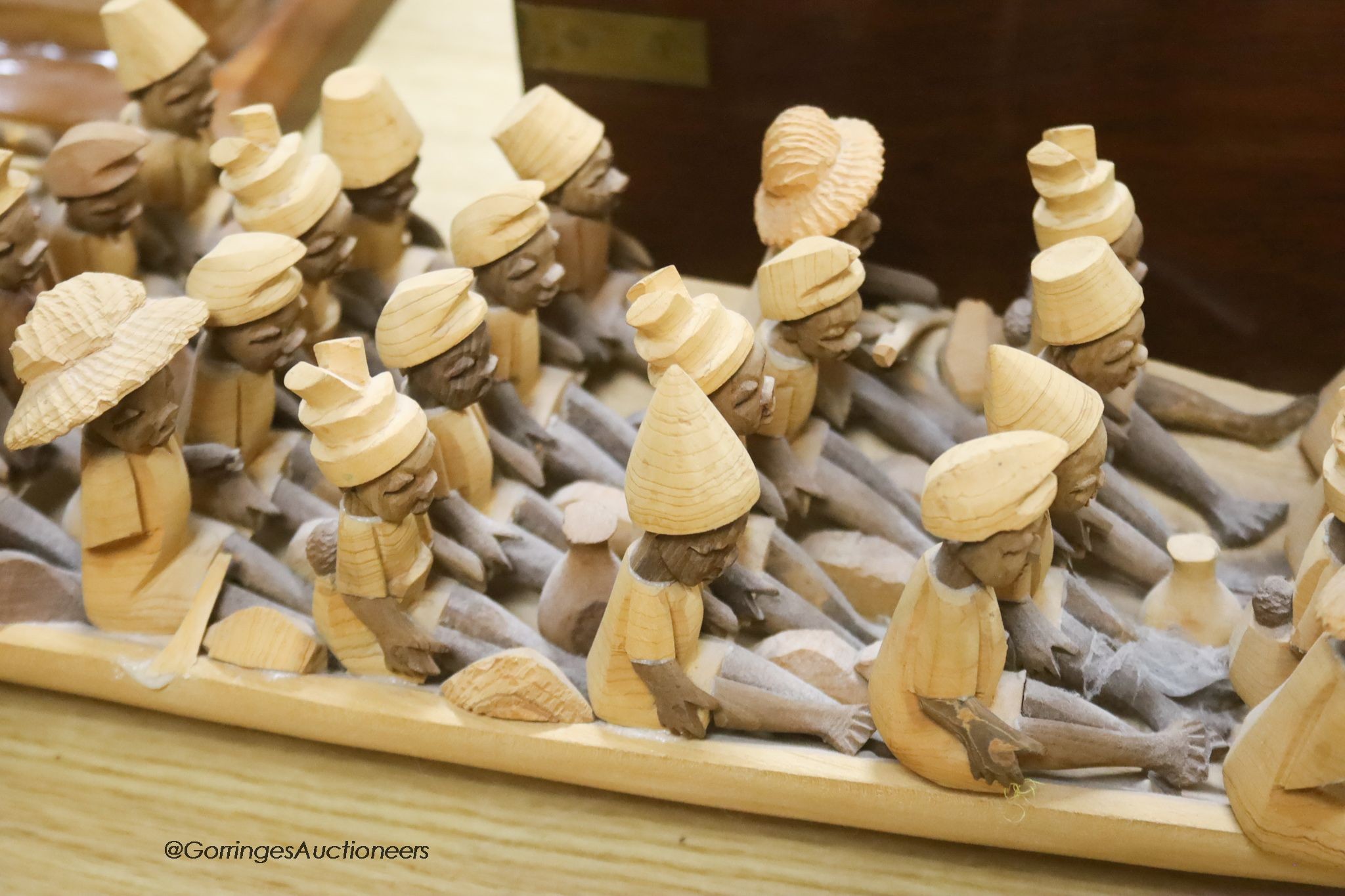 An African wood model of figures in a boat, length 155cm